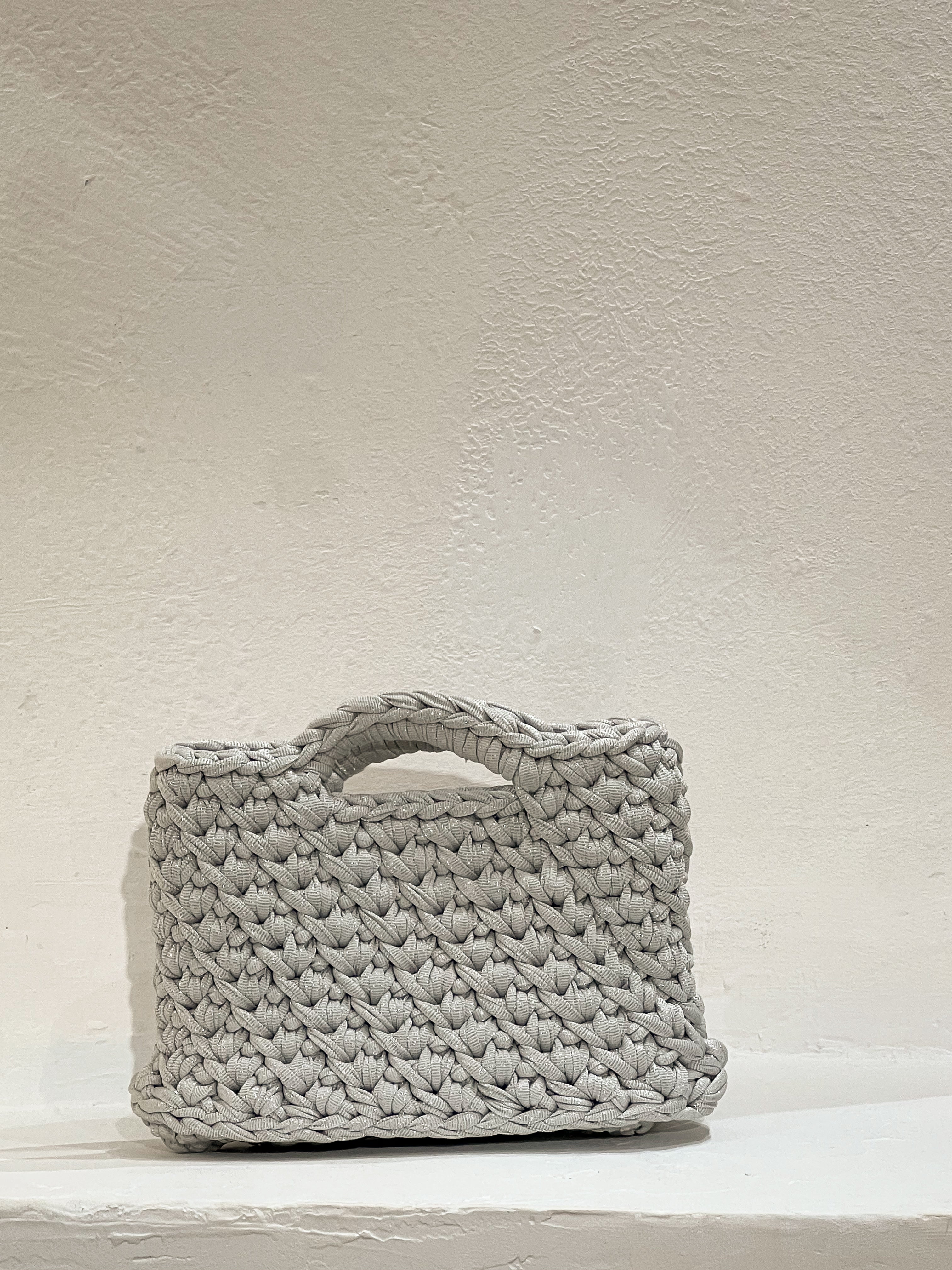 Bolso a crochet modelo Nela plata, tejido a mano con hilos reciclados y sostenibles por Nela Beach en Mallorca.
